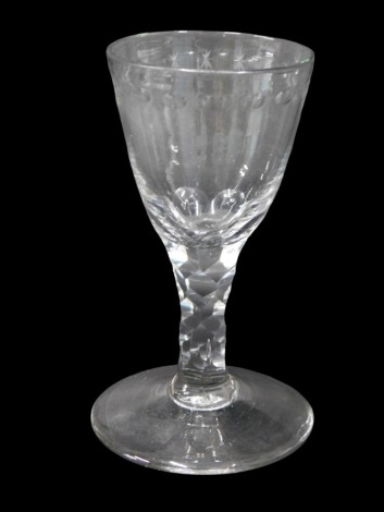 An early 19thC wine glass, with conical shaped bowl, with star cut and dimpled border and facet cut stem, 11cm high.