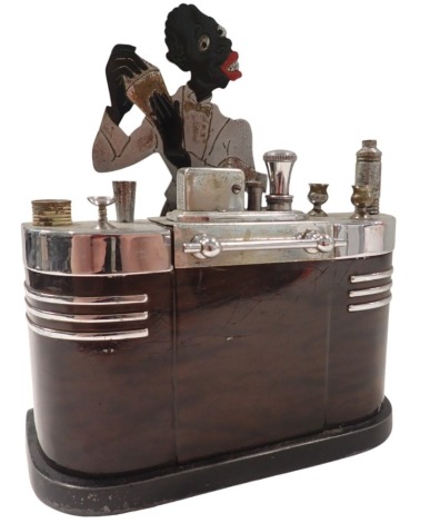 An Art Deco Ronson cigarette lighter, formed as a bar with cocktail shaking bar tender, 20cm high, 15cm wide, 6cm deep.