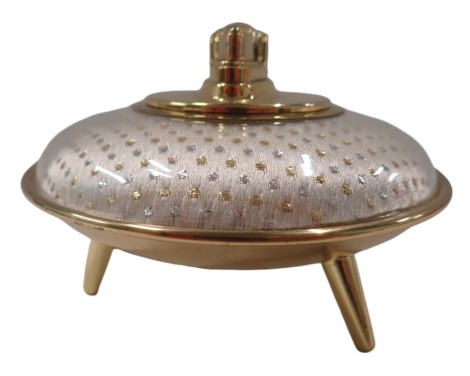 1950s/60s Ronson decor table lighter, the material gold and silvered buttoned top on tripod base, 8cm high, 11cm diameter.