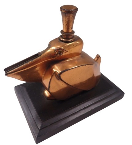 An Art Deco table lighter, in the form of a pelican in bronze finish, on a stepped rectangular base, 9cm high, 10cm wide, 6cm deep.