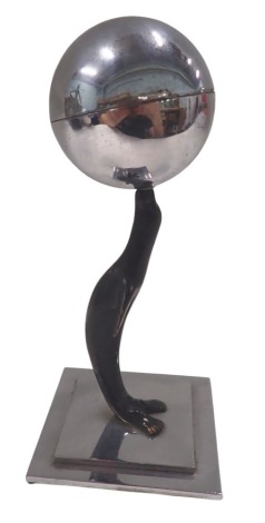 An Art Deco style table lighter, in chrome finish, formed as a seal with orb, on square stepped base, 15cm high, 8cm x 8cm base.