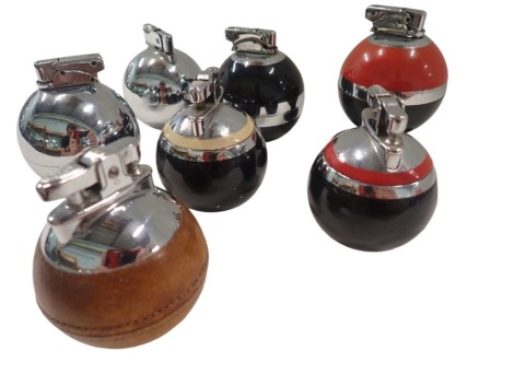 Six Art Deco orb table lighters, each black or chrome with enamel decoration, formed as an orb, to include Beney, Ronson, and others, the largest 10cm high, and a leather example. (7)