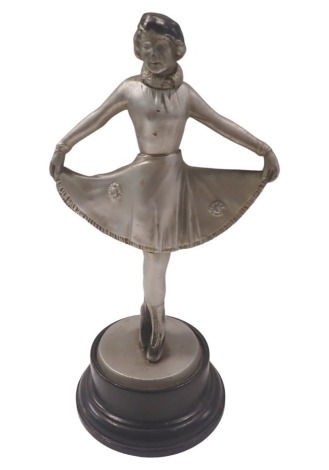 A Sonja Henie Art Deco style table lighter, formed as a lady dancing on a circular and ebonised foot, 30cm high. (AF)