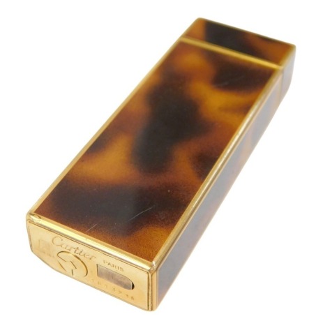 A Cartier pocket lighter, in imitation tortoiseshell casing, numbered 1843216, boxed.