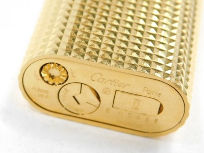 A Cartier pocket lighter, in gold coloured casing, numbered 056668, boxed. - 2