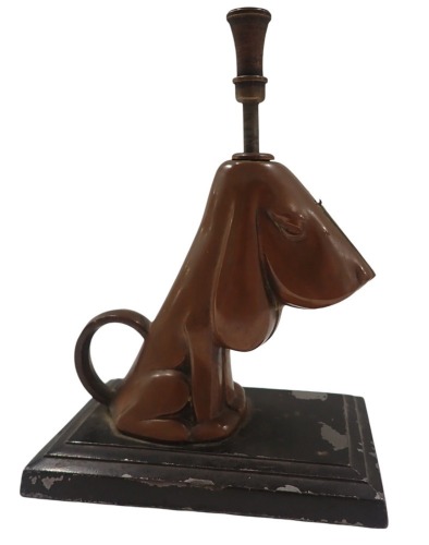 A Ronson table lighter, formed as a dog, in brass finish, on black finish metal base, 15cm high, 10cm wide, 6.5cm deep.