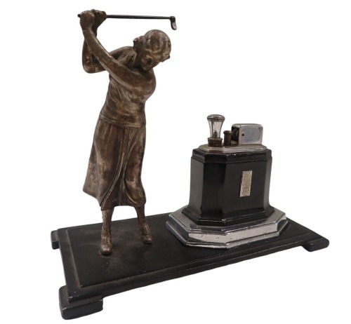 A Ronson Art Deco table lighter, formed as a female golfer, on black metal base, with chrome and black lighter, 16cm high, 19cm wide, 9cm deep.