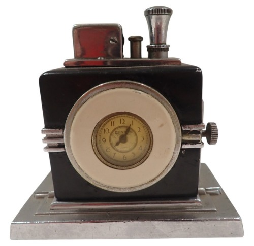 A Ronson Art Deco table lighter, formed as a clock face, with white enamel border, on black and chrome, 9cm high, 10cm wide, 5cm deep.