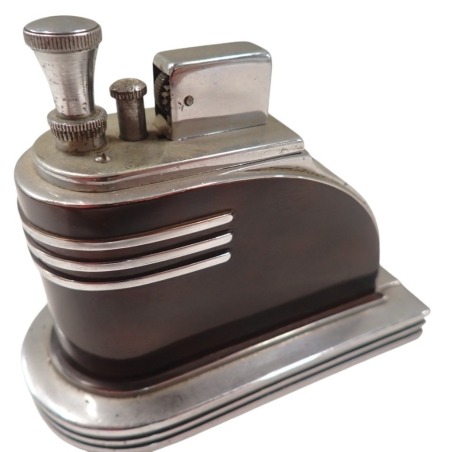 A Ronson touch tip Art Deco table lighter, of arched form with imitation tortoiseshell body, with chrome fitments, 10cm high, 11cm wide, 5cm deep.