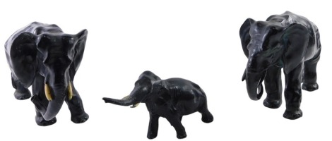 Three metal elephants, the large example stamped AMW, 14cm high, and a smaller example, 7cm high. (3)