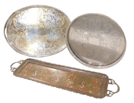 Three serving trays, comprising an Eastern enamel decorated tray, with pheasants and flowers, 73cm diameter, a circular silver plated and pierced galleried tray, 36cm wide, and an oval and pierced galleried tray, 53cm diameter. (3)