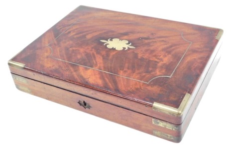 A 19thC mahogany stationery box, with brass bound borders and central panel, opening to reveal a brushed velvet topped interior, 9cm high, 40cm wide, 29cm deep.