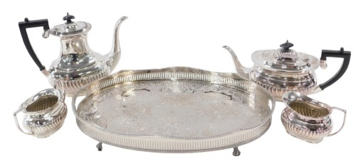 20thC silver plated wares, comprising an EPNS four piece tea and coffee service, each with ebonised handles, and fluted body, and a silver plated oval galleried serving tray, ball and claw feet, 45cm x 30cm. (5)