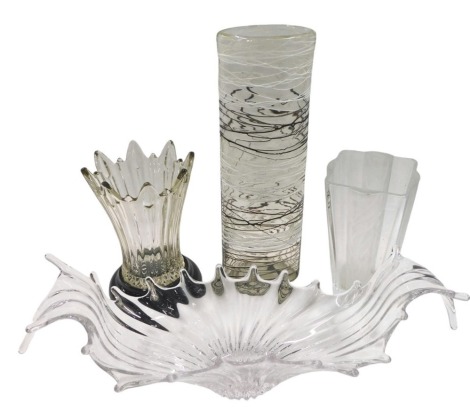 Four items of glass, comprising a clear centre bowl, 52cm diameter, a fluted stem vase on ebonised base, 22cm high, a further frosted glass vase, 22cm high, and a white and black ribbed Art Glass vase, 41cm high. (4)