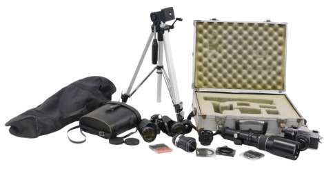 Camera and optics equipment, comprising an aluminium flight case, with a Prinz Galaxy 1-6.3 400mm zoom lens, various lens cap covers, a Praktica Super TL1000 camera, a Pentacon Auto 1.8-50 lens, a Soligor 1-3.5 135mm lens, a Phago converter, camera tripod