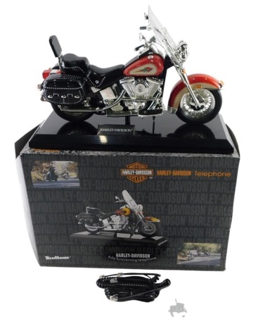 A Tele Mania Harley Davidson model telephone, the red bike boxed.