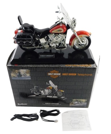 A Tele Mania Harley Davidson model telephone, the red bike boxed.