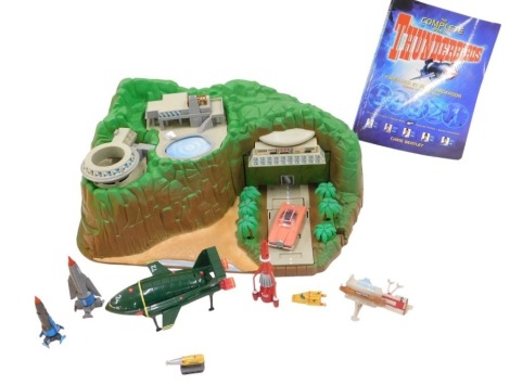 A Thunderbirds Tracy Island model, Thunderbird 1-5 figures, Thunderbirds book and a Lady Penelope car.