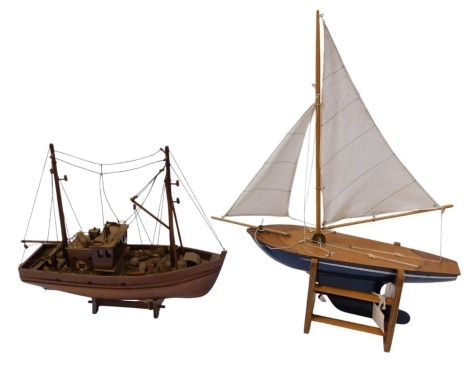 Two 20thC model boats, comprising a 1950s Star style pond yacht, on wooden base, 55cm high, and an east coast dredger, 38cm high. (2)