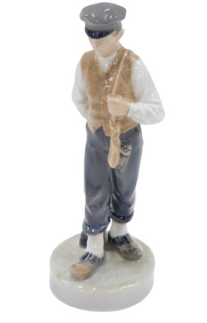 A Royal Copenhagen figure, of a boy carrying mallet, stamp to underside, 22cm high, numbered 620.