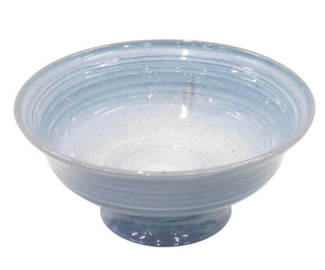 A Studio pottery centre bowl, on lubbed foot, on a blue glazed ground, unmarked, 12cm high, 23cm diameter.