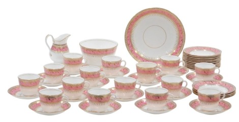 An early 20thC tea service, on a white ground with pink border, picked out in gilt, to include cake plate, milk jug, sugar bowl, fifteen tea cups and saucers, and ten side plates.