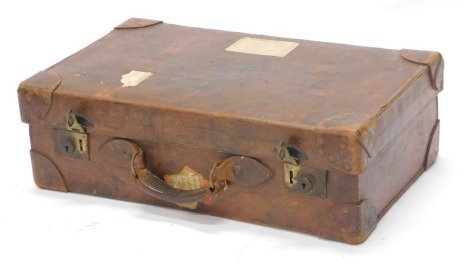 A 20thC leather travel case, bearing the initials JB, brass lock plates, 20cm high, 67cm wide, 40cm deep.