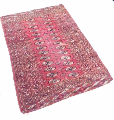 A Nepal rug, on a red ground, with geometric borders, bears label, 174cm x 91cm.