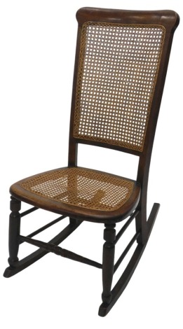 A late Victorian ash and stained beech rocking chair, with woven cane seat and high back, with turned legs and stretchers.