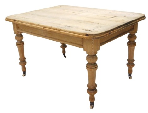 A Victorian pine scrubbed top kitchen table, with rectangular top, having moulded corners and border, on turned and tapered legs, with pot castors, 130cm x 92cm x 74cm high.