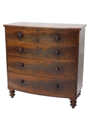 A Victorian figured mahogany bow fronted chest, of two short and three long drawers, with turned knop handles, and low turned bun feet, 104cm high, 109cm wide, 54cm deep.