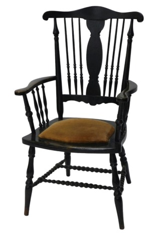 A late Victorian ebonised open arm chair, with spindle back and arm supports, padded seat and bobbin turned stretchers, with turned legs.