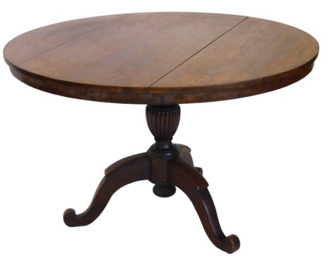 A 19thC oak circular centre table, with plain frieze and fluted baluster column, with three haunched stylised scrolling legs, 116cm diameter, 72.5cm high.