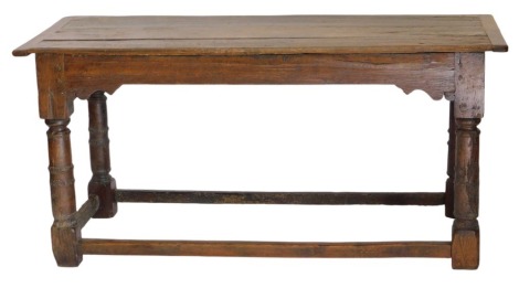 A 17thC and later oak plank top dining table, with cleated ends, above shaped frieze, and canon barrel turned legs, with plain outer stretchers, 153cm x 62cm x 72cm high.