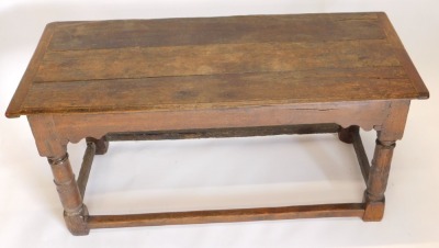 A 17thC and later oak plank top dining table, with cleated ends, above shaped frieze, and canon barrel turned legs, with plain outer stretchers, 153cm x 62cm x 72cm high. - 2