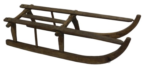 A traditional wooden framed sledge, the runners and work stamped OS, 102cm long.