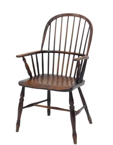 A 19thC elm and ash comb back Windsor chair, with slender turned stretchers, and turned legs, with shaped seat.