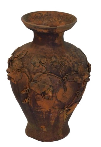 A terracotta garden urn, with flared neck, and partial fluting vine decoration, applied in relief, 62cm high. (AF)