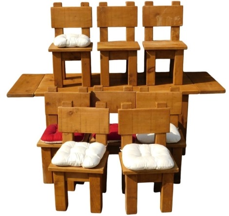 A modern dining table and a set of eight chairs, of heavy pine plank and block construction, dining table with two additional leaves, 82cm x 88cm x 81cm high.