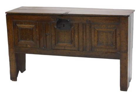 A small 18thC oak coffer, with plain hinged lid and triple panelled front, on stile legs, with iron lock plate, 70cm high, 118cm wide.