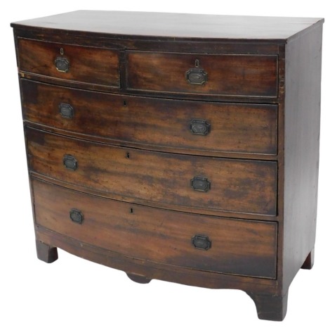 A George III mahogany bow fronted chest of two short and three long graduated drawers, with brass oval handles with shaped back plates, 106cm wide.