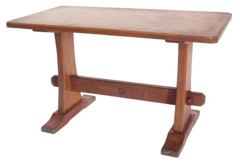 A small oak Alan Grainger 'Acorn Man' oak coffee table, with shaped and chamfered rectangular top, with adz figuring, on a refectory style base with tapered flat end supports and low flat feet, 76cm x 39cm.