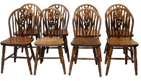 A set of eight stained beech wheelback dining chairs.