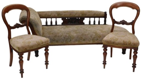 An Edwardian walnut framed chaise longue, with raised padded spindle back, and carved decoration the front scroll support, on turned legs, upholstered in cut moquette, and a pair of Victorian balloon back chairs, upholstered in the same fabric.