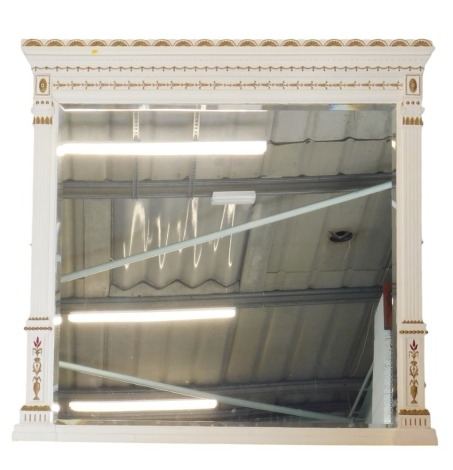 An Edwardian overmantel mirror, with arcaded gallery cornice, and swag and hair bell decoration, flat reeded pillars to the side of the bevelled glass, later painted decoration and highlighted in gilt, 142cm high, 46cm wide.