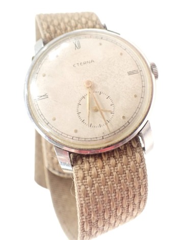 An Eterna stainless steel cased gent's wristwatch, with a silvered coloured dial, with Roman numeric border, and seconds dial with gold coloured hands, in stainless steel case, on a material tan strap, the dial 3.5cm diameter, boxed.