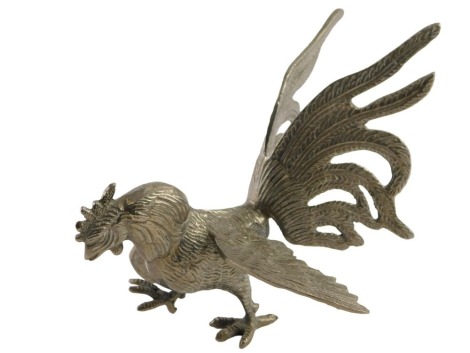 A 20thC silver plated cockerel ornament, feeding at ground, 15cm high.