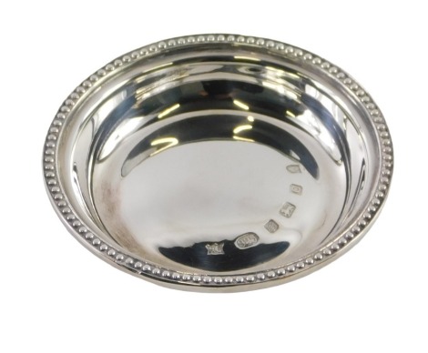 An Elizabeth II silver pin dish, with beaded border, maker HC, Sheffield 2002, 1.23oz.