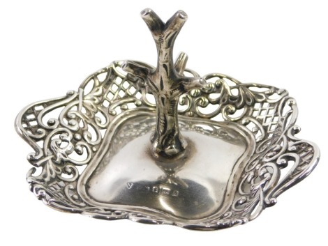 An Edward VII silver dressing table ring stand, the centre formed as a tree, in pierced basket outer border, hallmarks rubbed, believed to be Birmingham 1901, 1.52oz.