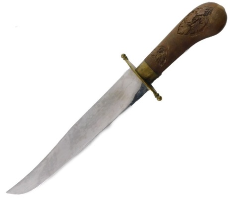 A Middle Eastern dagger, the wooden carved handle depicting flowers and vines, on a stainless steel curved blade, 27cm long.